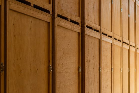 The plywood doors and latch hardware of storage vaults standing in a row